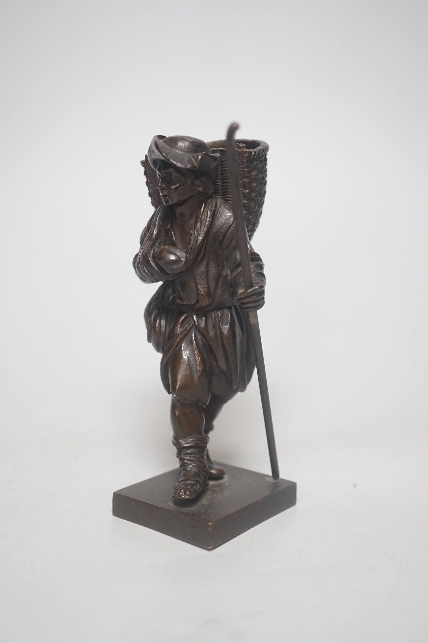 A 20th century bronze of a travelling salesman. 15cm tall